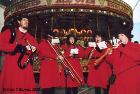 busking in front of the Gallopers